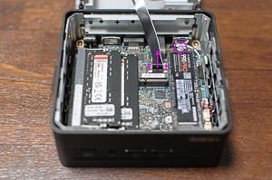 "The bottom cover is connected to the motherboard with a SATA cable, detach it before you continue; also remove the NVMe screw"