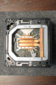 "The assembled _NUC_ with the hole at the top, showing a bit of the heatsink's thermal pad"